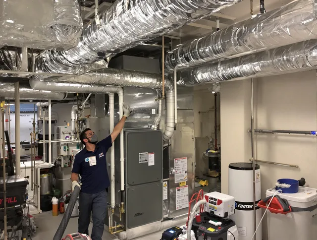 Norfolk Air Duct Cleaning specialist performing thorough furnace duct cleaning in a Norfolk residence