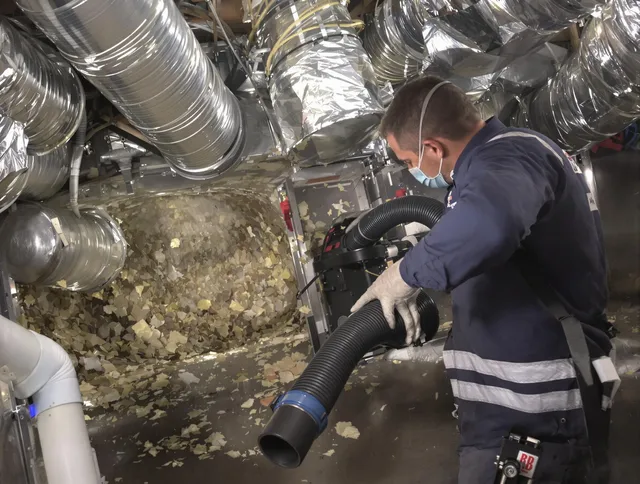 Norfolk Air Duct Cleaning specialist operating negative pressure cleaning equipment for thorough duct maintenance in Norfolk