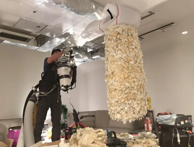Norfolk Air Duct Cleaning technician performing precision vacuum insulation removal in a residential property in Norfolk