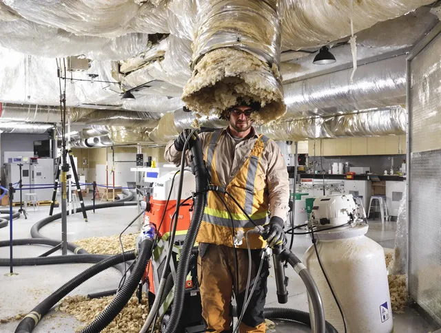 Professional vacuum insulation removal by Norfolk Air Duct Cleaning expert in Norfolk